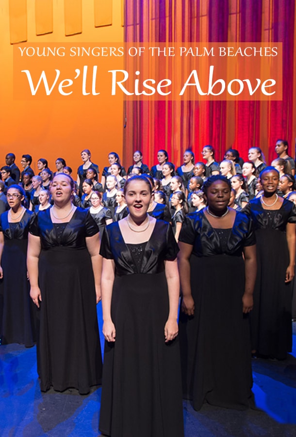 Five girls stand in focus, singing in black performance dresses with the rest of the choir just behind them. The backdrop is orange and pink/purple with the title "Young Singers of the Palm Beaches: We'll Rise Above" over their heads.