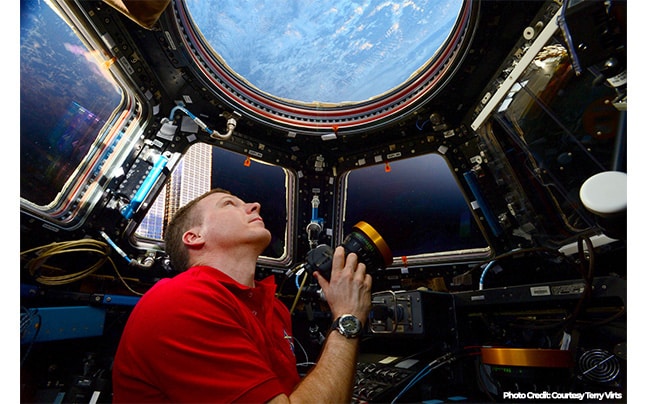 Terry Virts in ISS Holding Camera looking at Earth
