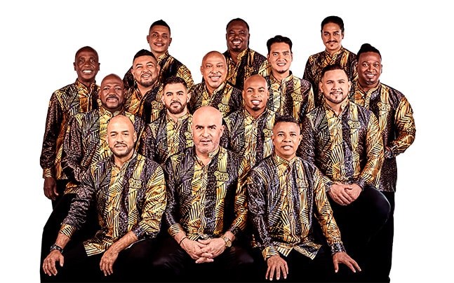 Grupo Niche posing in Black and Gold uniforms, white background