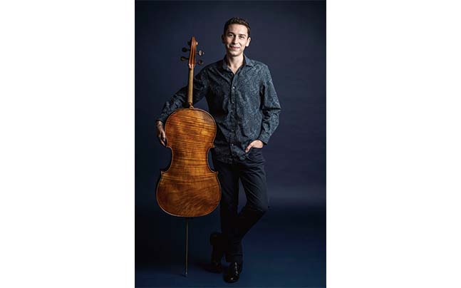 Oliver Herbert posing with cello