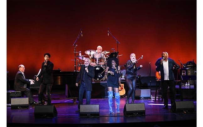 Neil Berg on stage with other singers and band