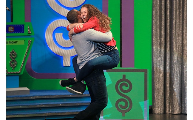Price is Right contestants hugging.