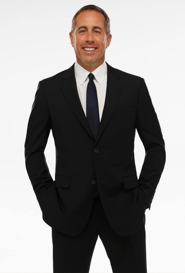 Jerry Seinfeld hands in pockets in Suit and Tie