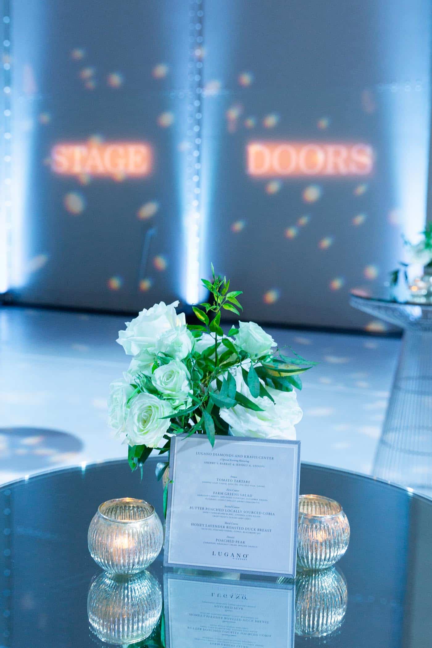 Cocktail table featuring menu and flowers.