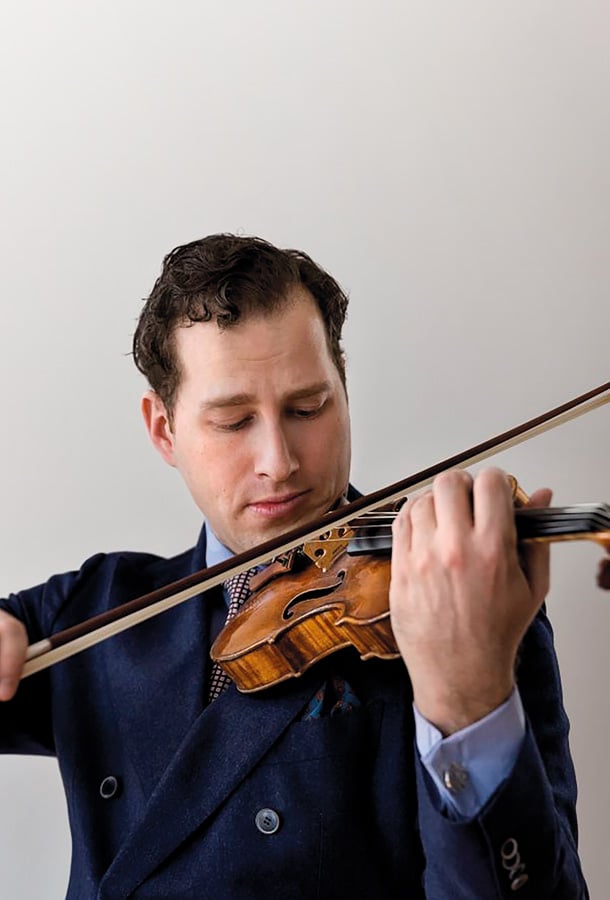 Nikolaj Szeps-Znaider playing violin wearing blue suit.