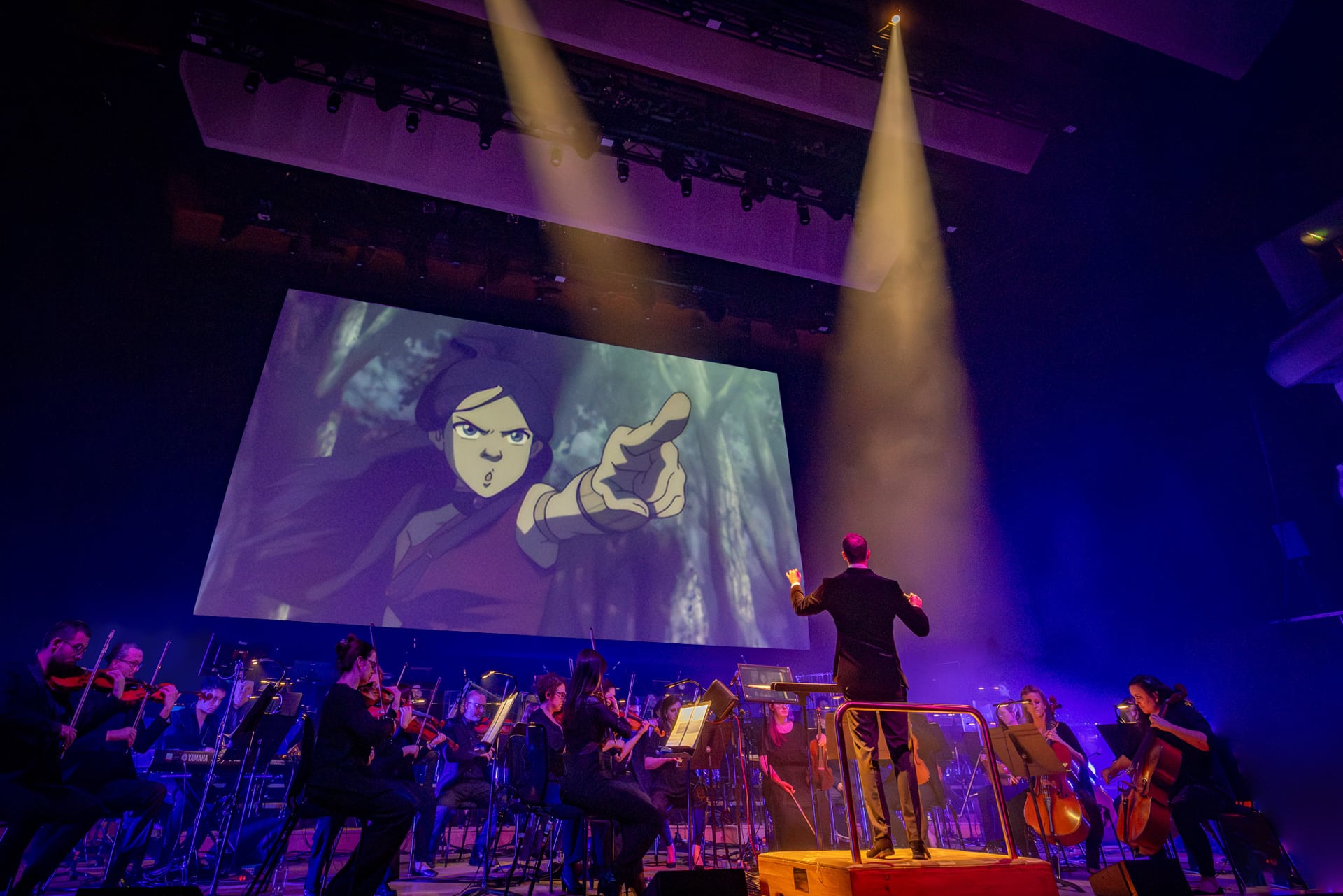 Avatar Concert on stage with orchestra with large screen playing show clips