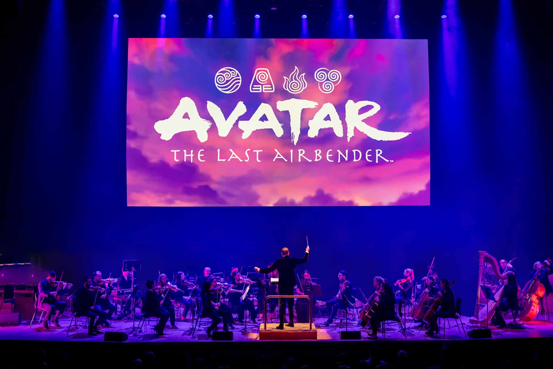Avatar Concert on stage with orchestra playing AVATAR on screen