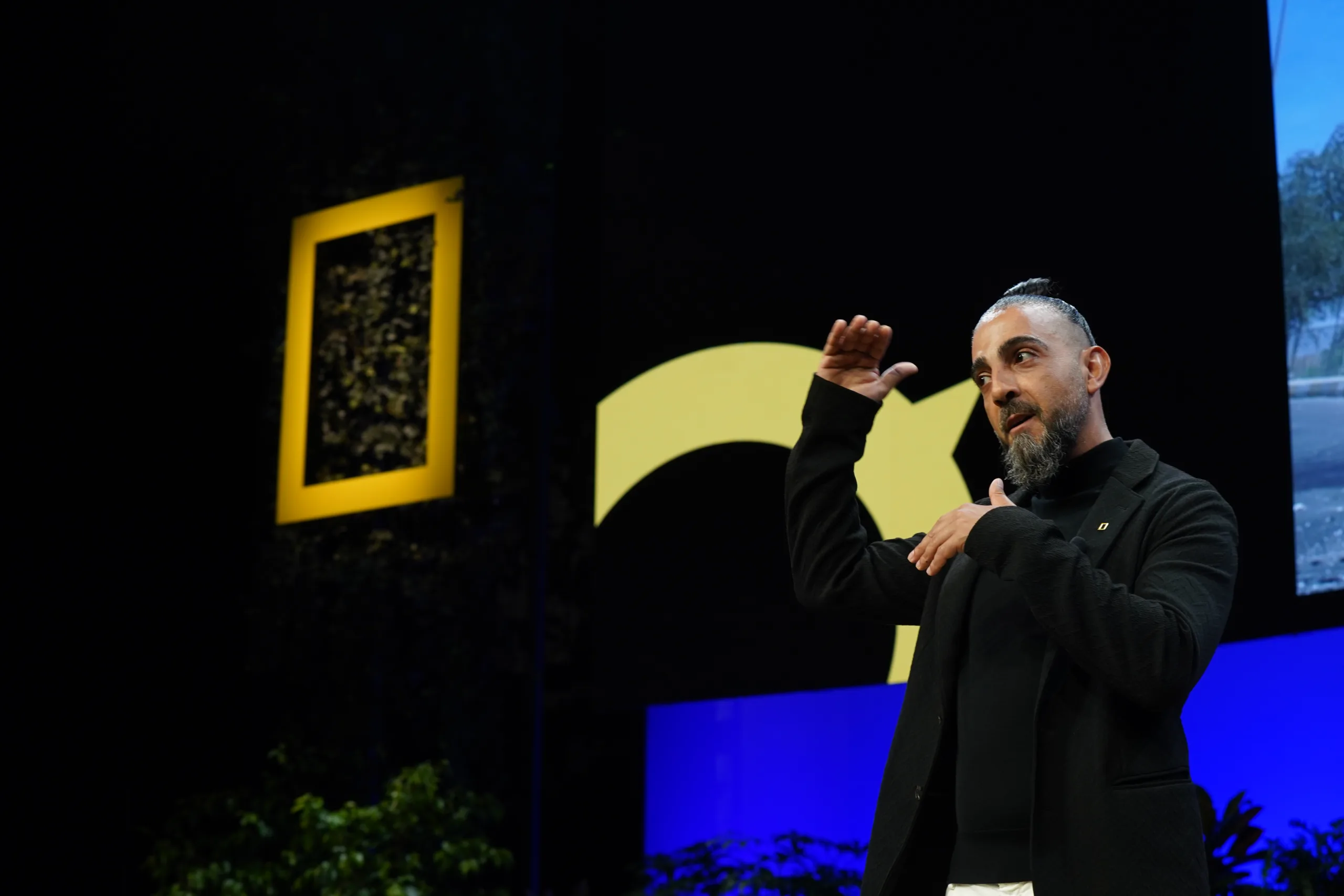 Muhammed Muheisen presenting on stage