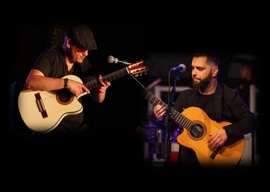 Gyorgy Lakatos and Lennis Sabatino playing guitar on stage