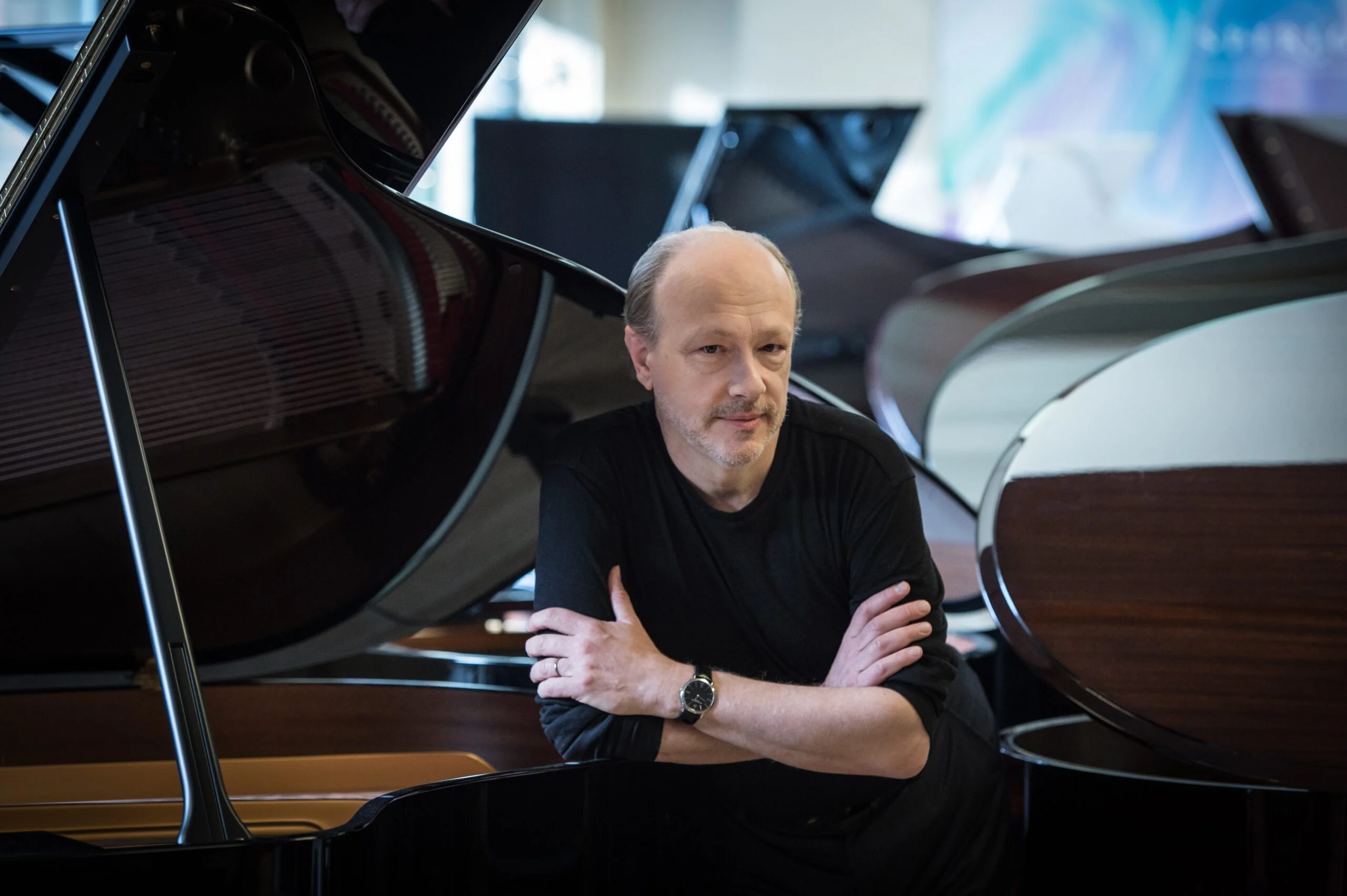 Marc-André Hamelin headshot surrounded by piano covers.