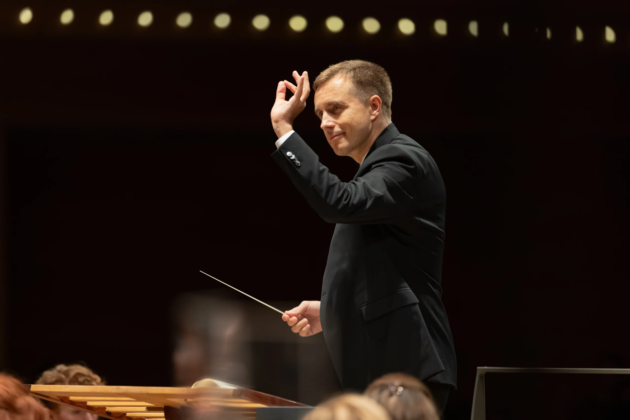 Petrenko Vasily conducting orchestra with baton.