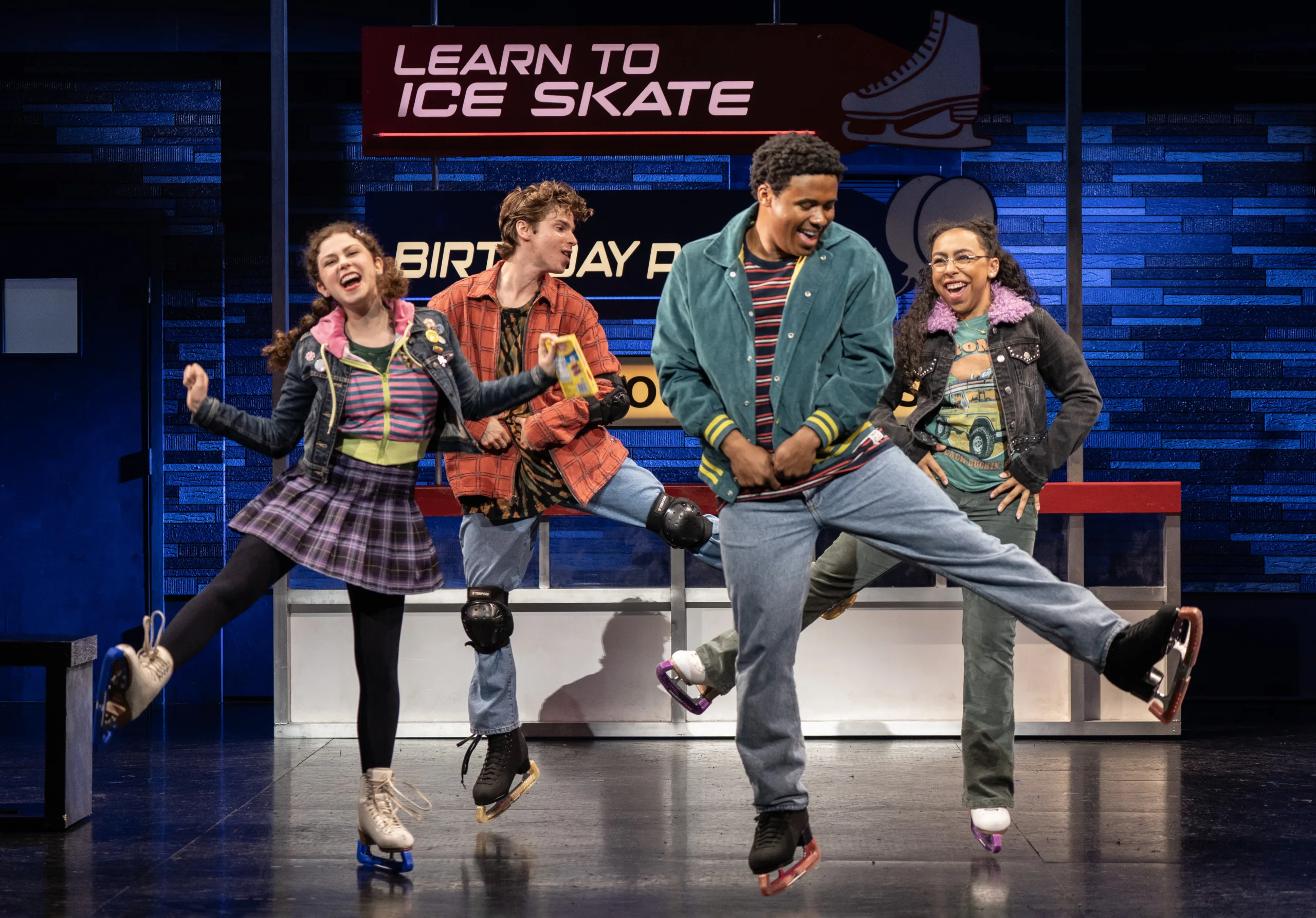 Four characters on stage all standing with one leg in the air stretched at a diagonal. 