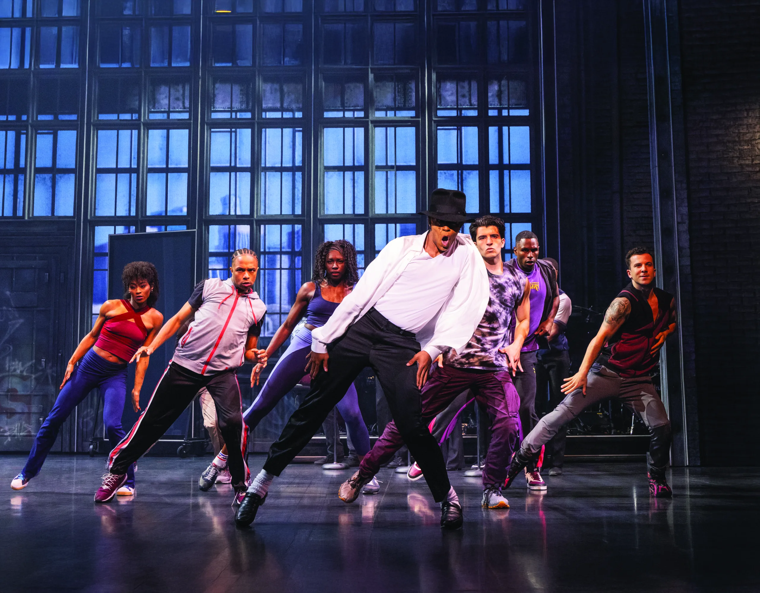 MJ in the middle with he and the cast leaning to one side with shoulders popped.  