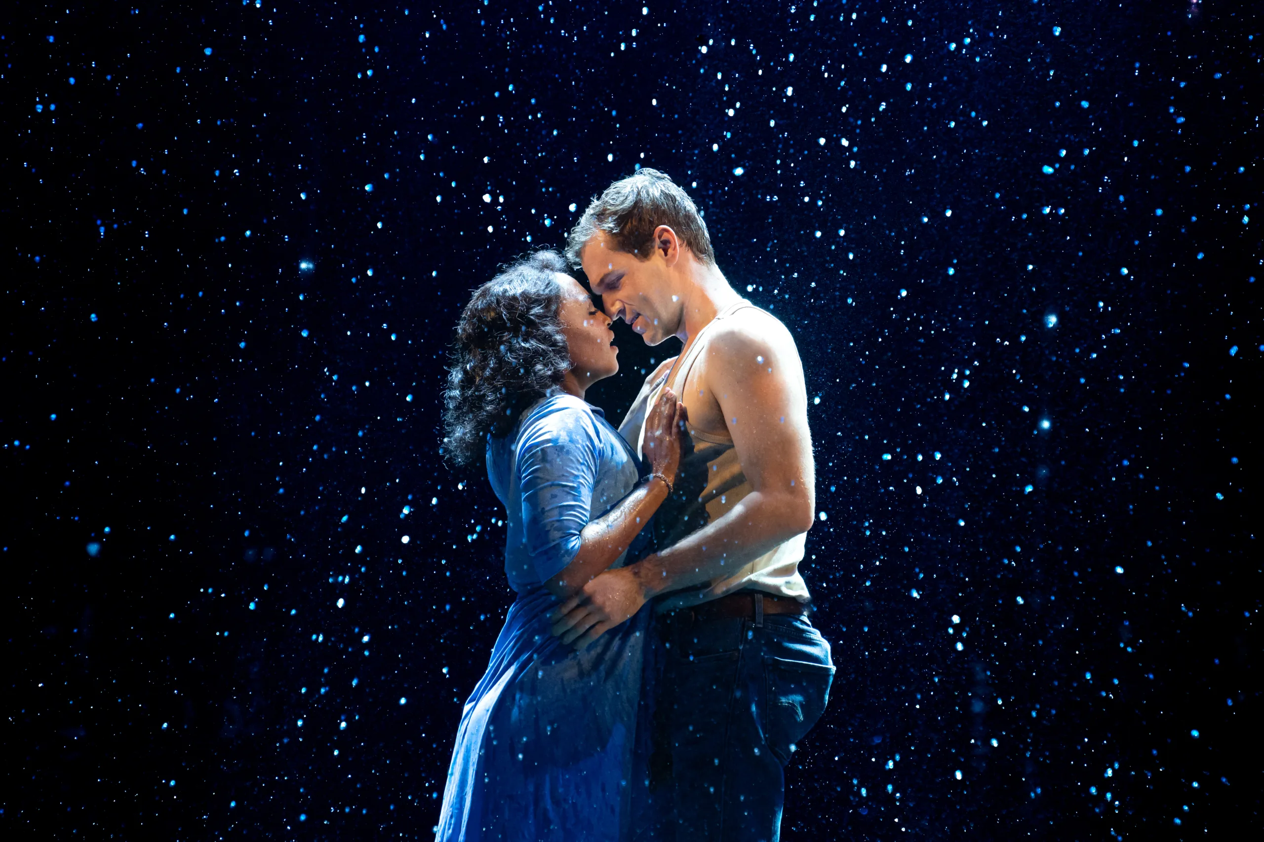 Middle Allie and Middle Noah standing and embracing in the rain. 