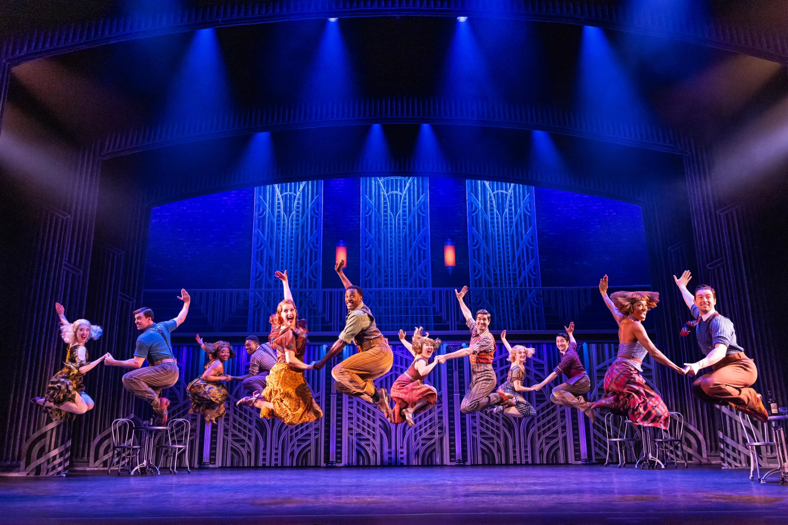 The First National Touring Company of SOME LIKE IT HOT dancing and jumping with legs up in the air. 