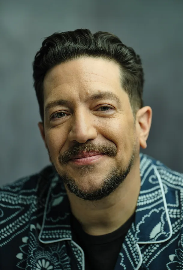 Sal Vulcano headshot wearing a blue and white floral collared shirt smiling into the camera.