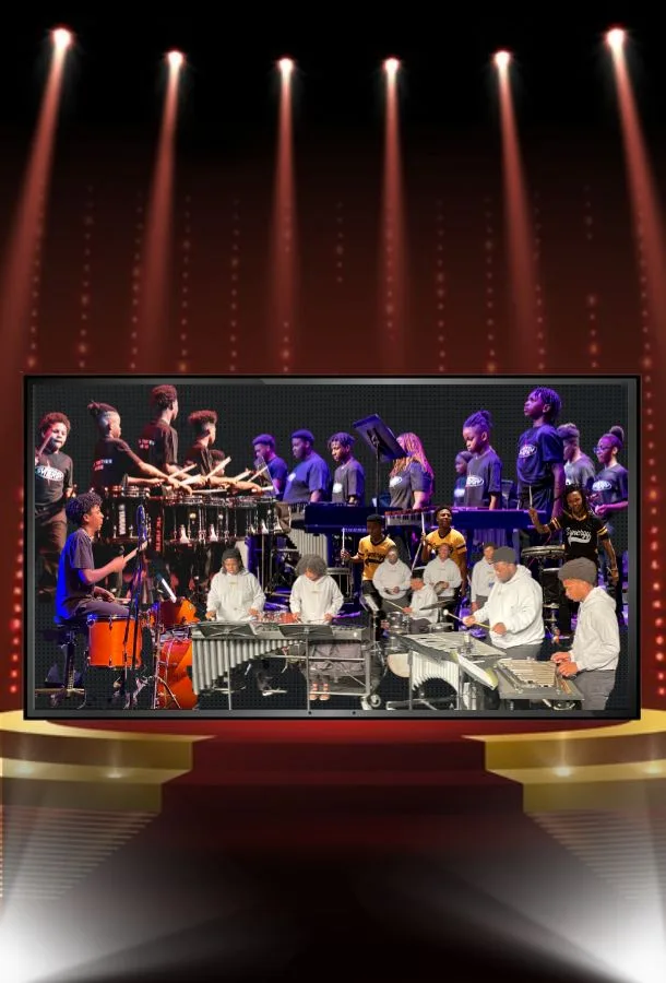 students playing instruments with a a red carpet leading to a stage and lights.