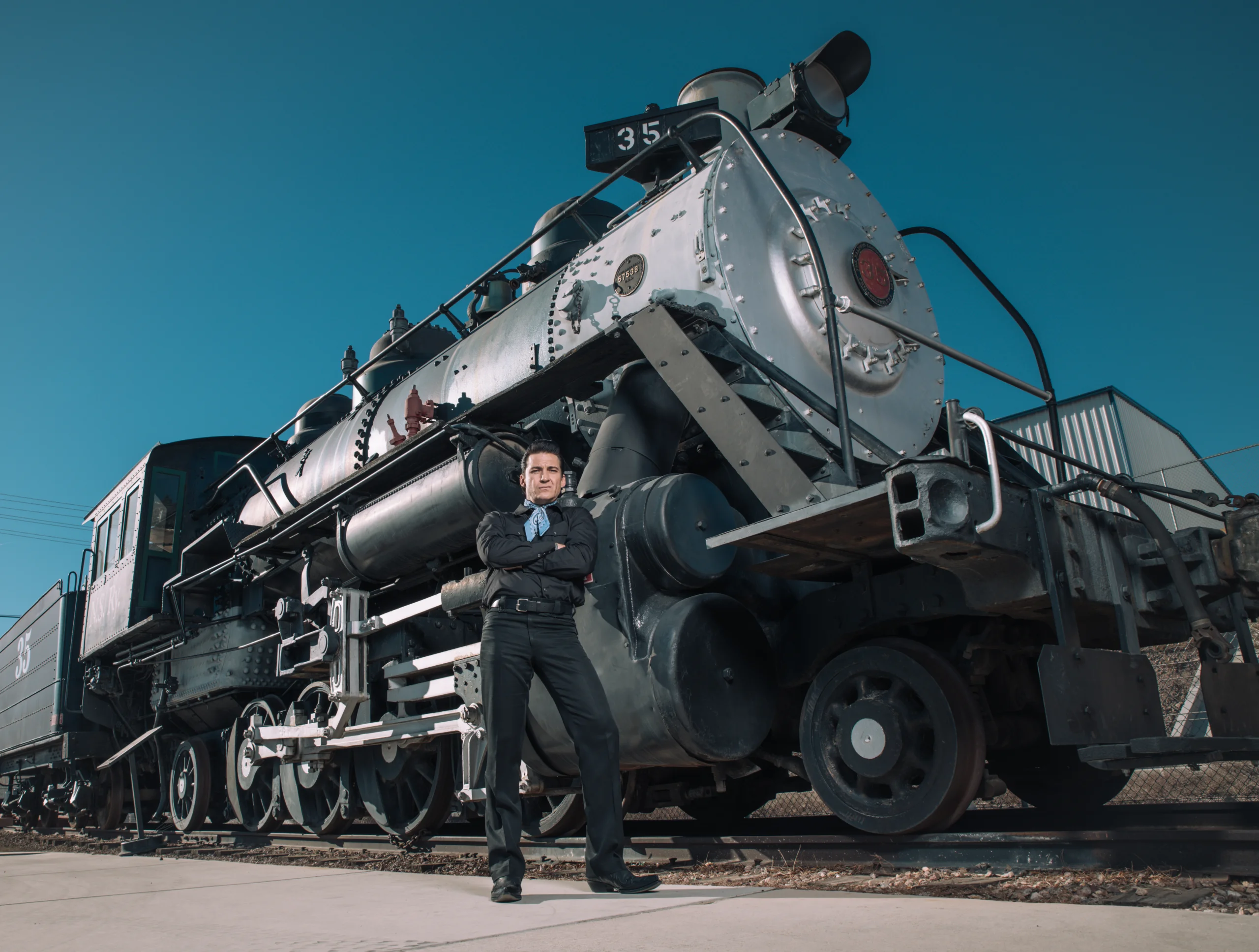 Shawn Barker poses in front of train.