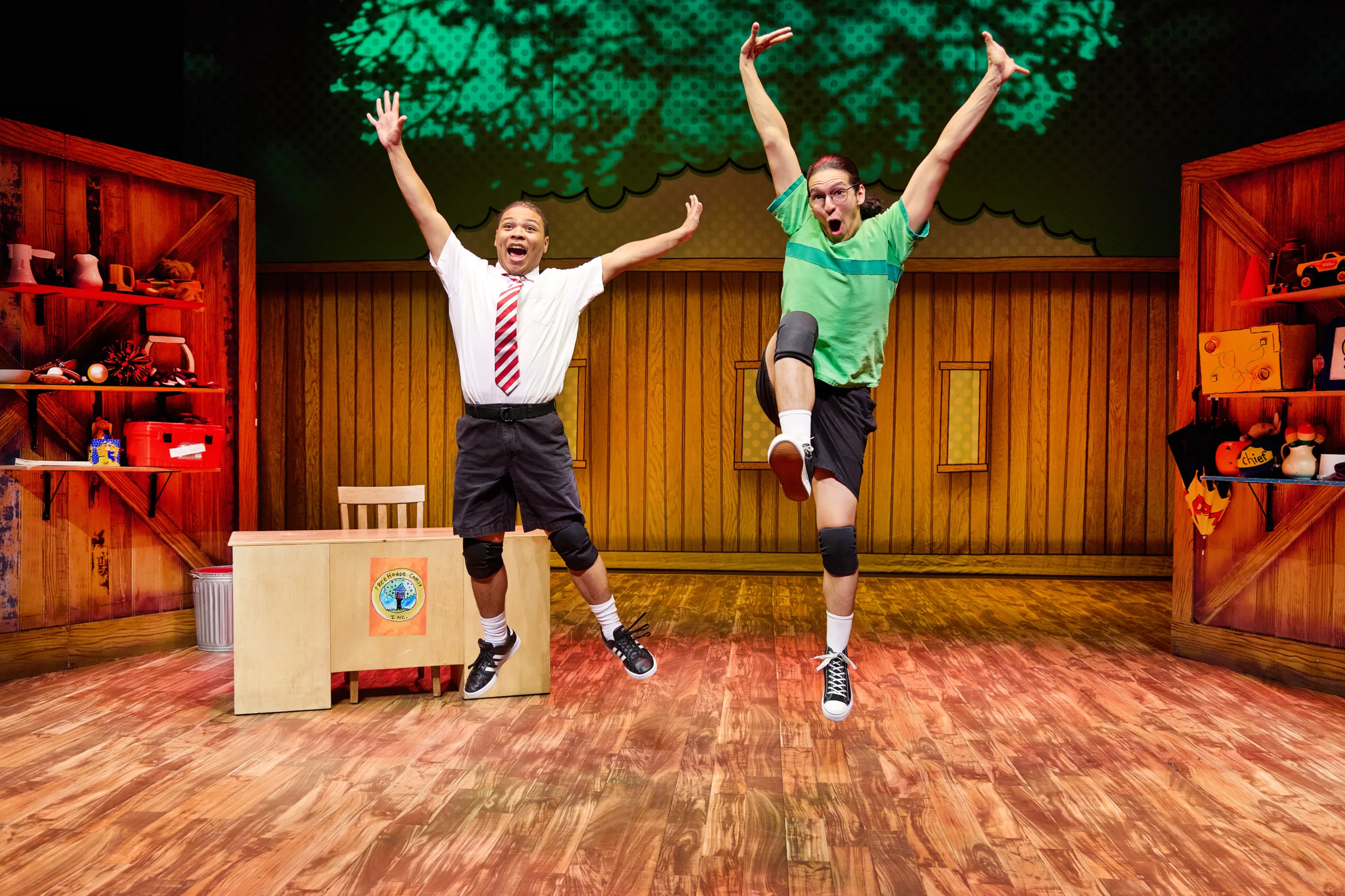 Marquise Neal and Mundo Ballejos on stage in costume leaping in the air.