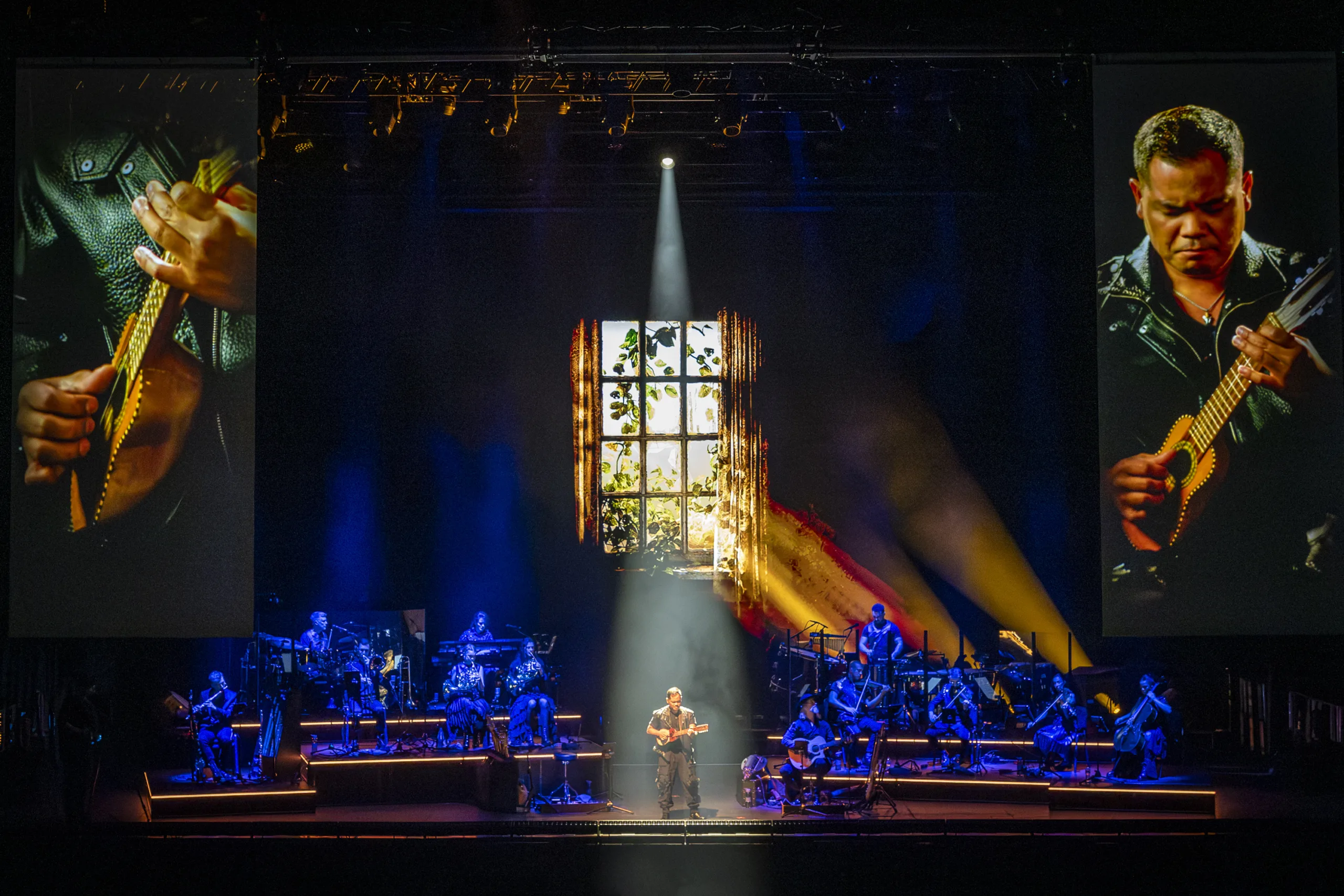 The band on stage with projections from 