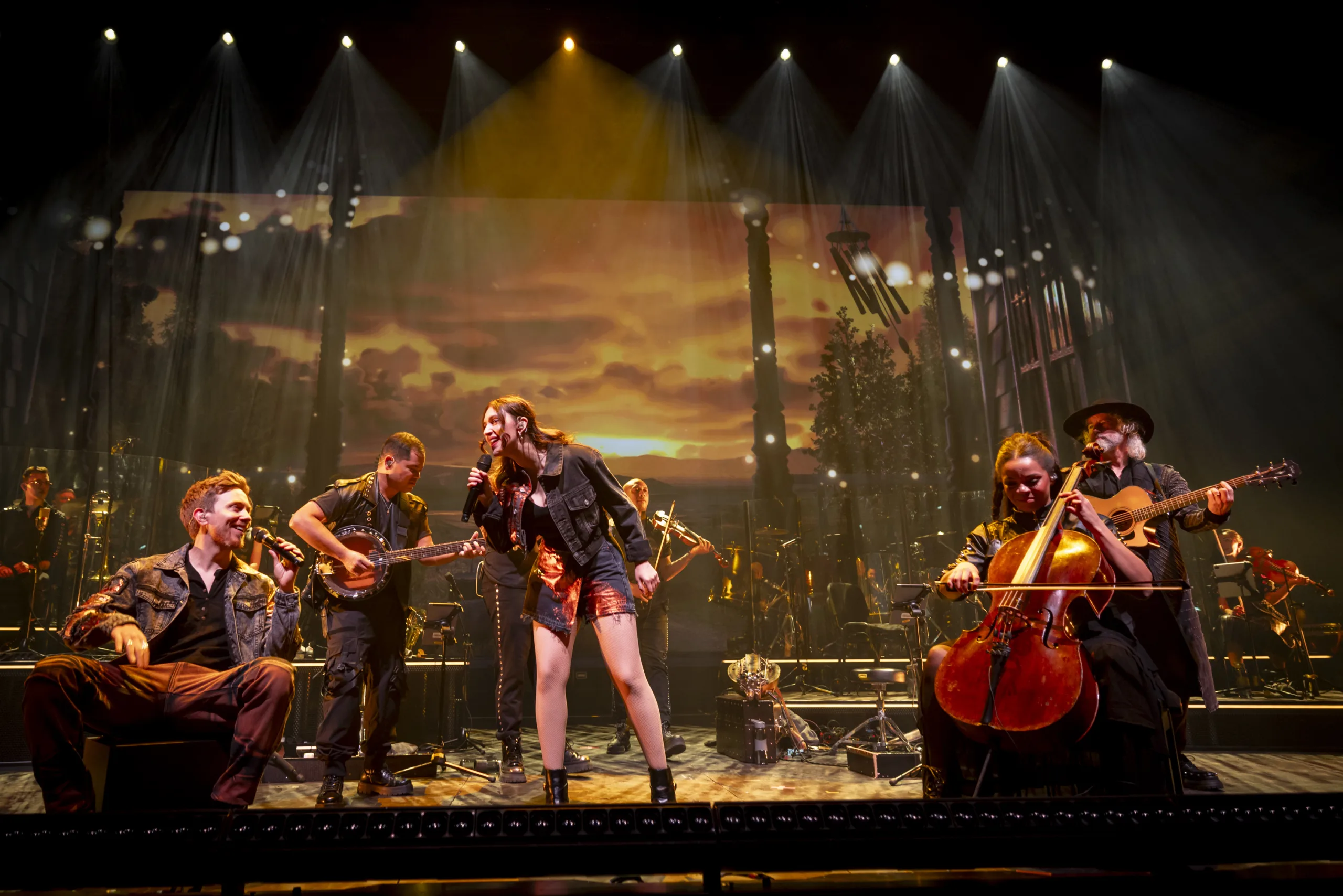 The band on stage with projections from 