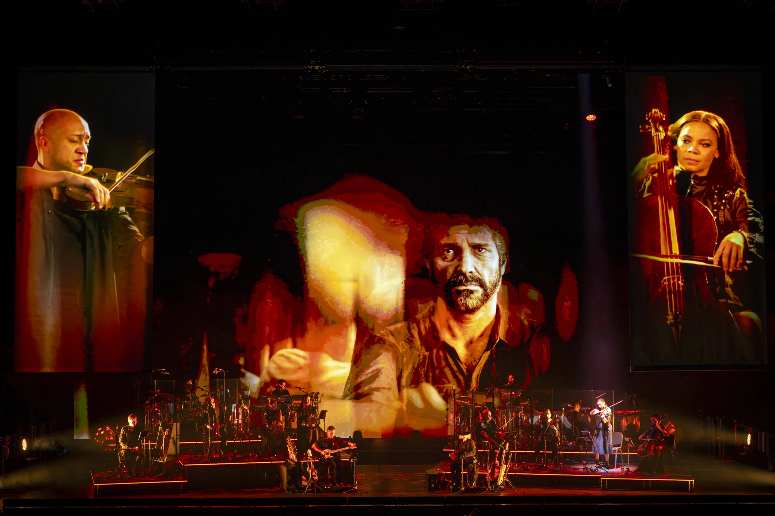 The band on stage with projections from 