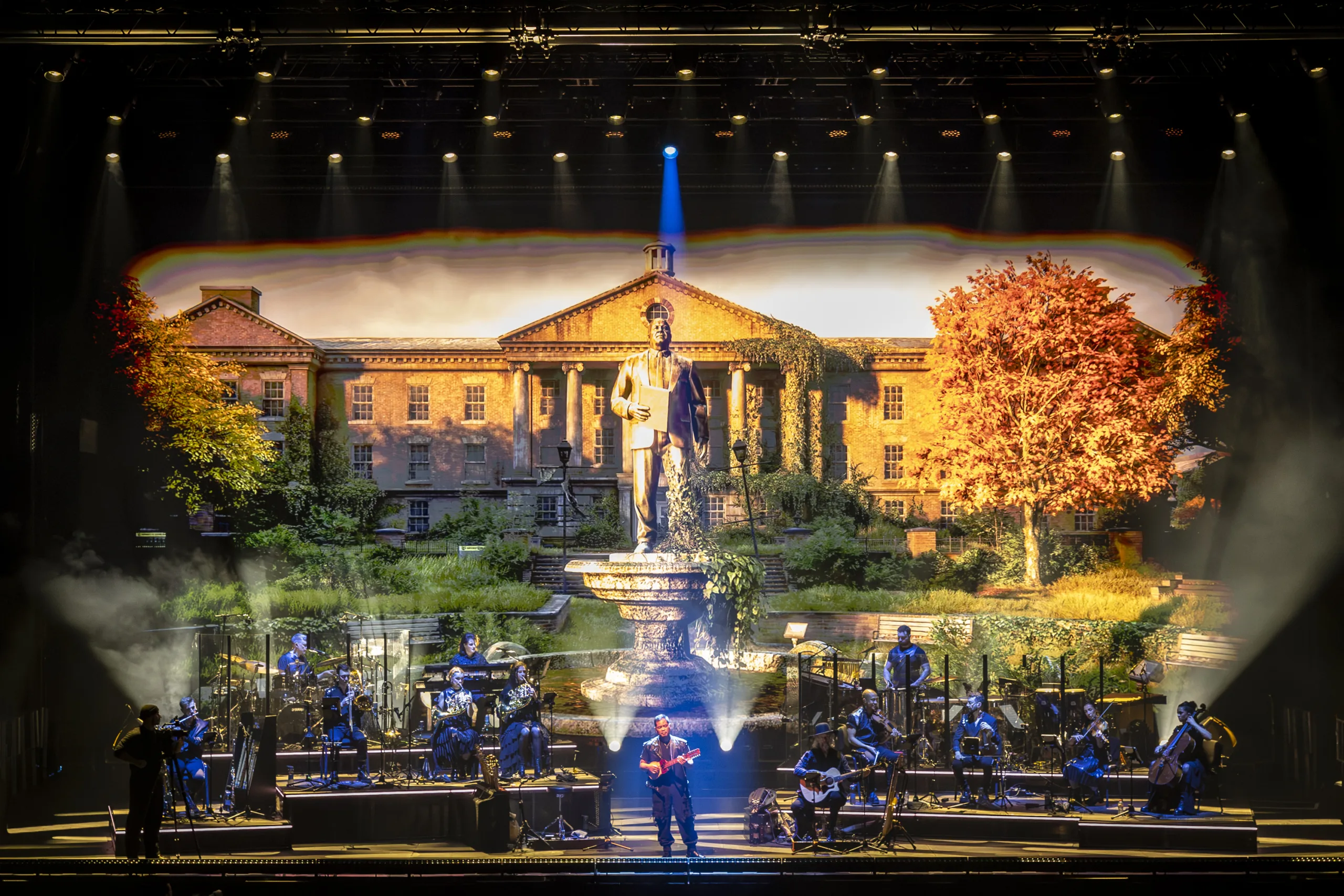 The band on stage with projections from 