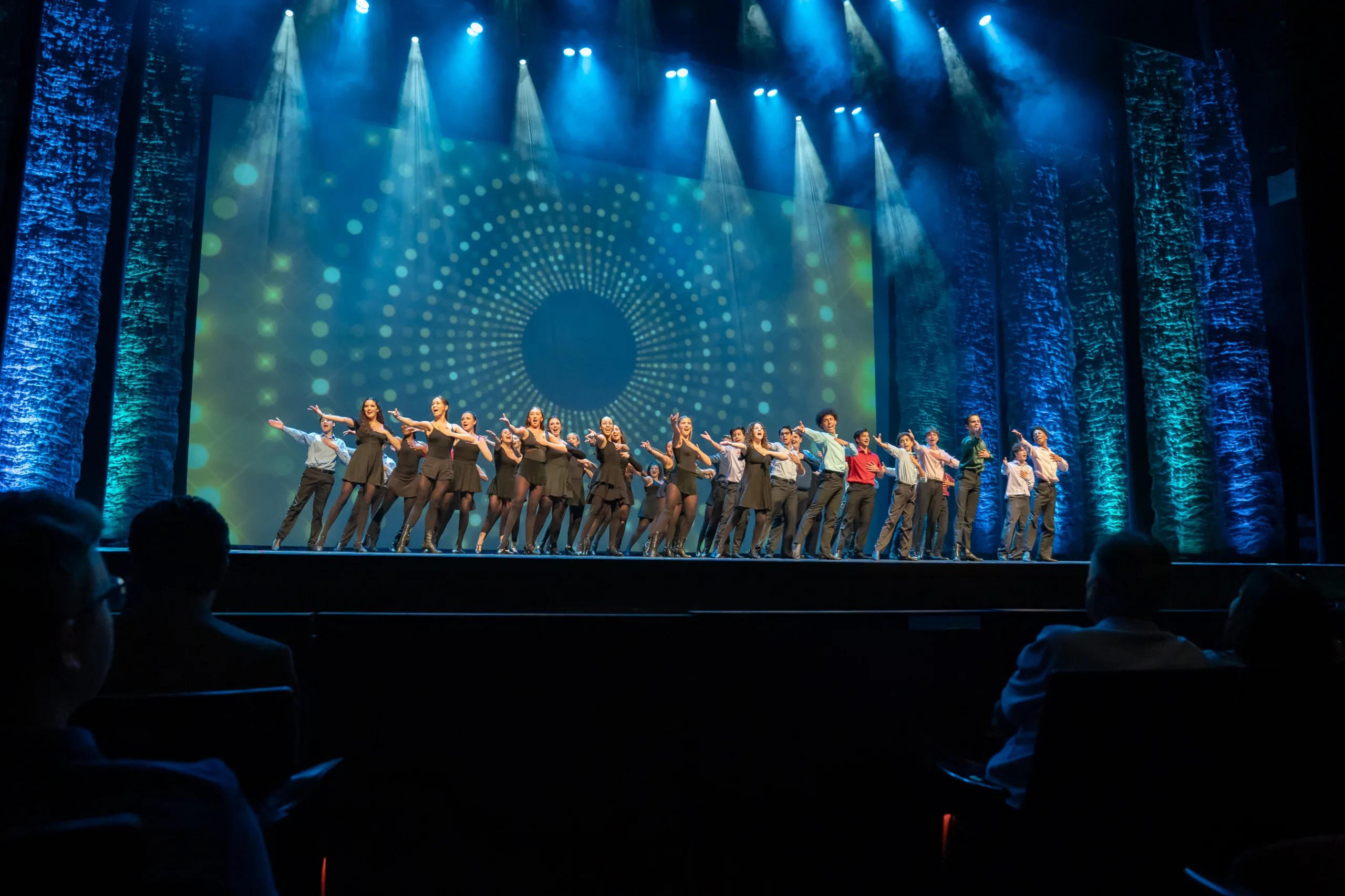 Dream Awards performers on stage all pointing with extended arms to stage right.