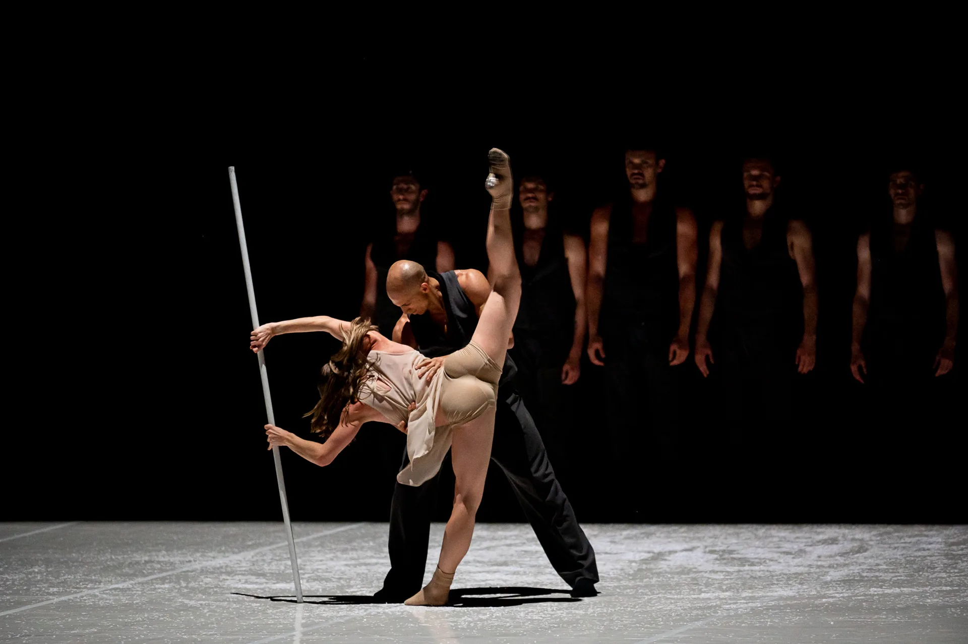 Dancer on stage with leg extended vertically balancing.