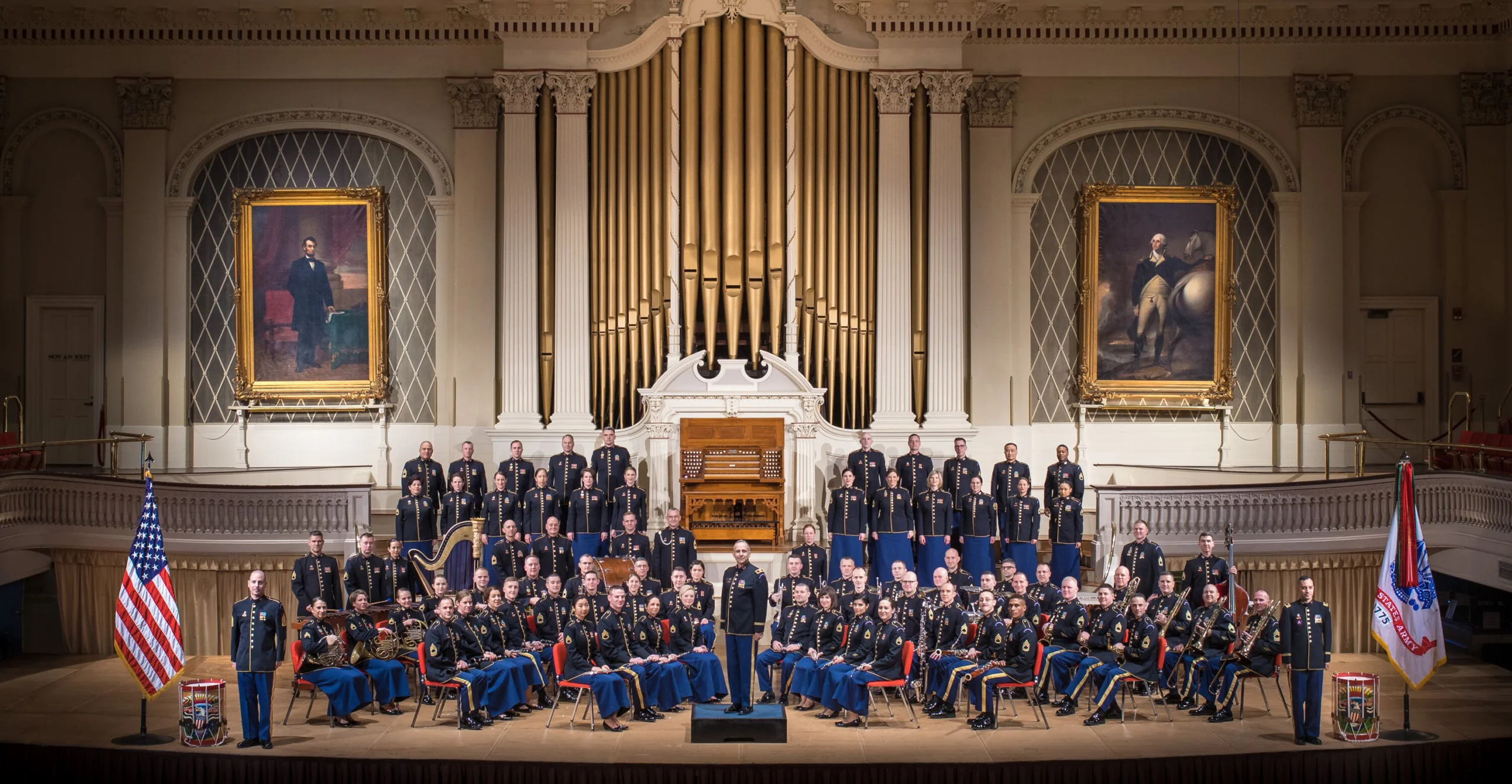 The United States Army & Soldiers Chorus pose in uniform from stage.