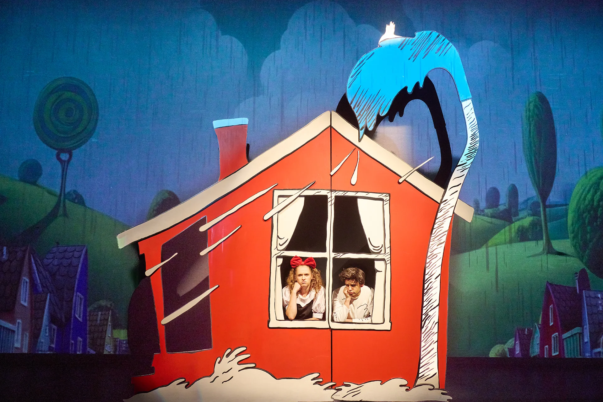 A little red house in Dr. Seuss art style on stage. 