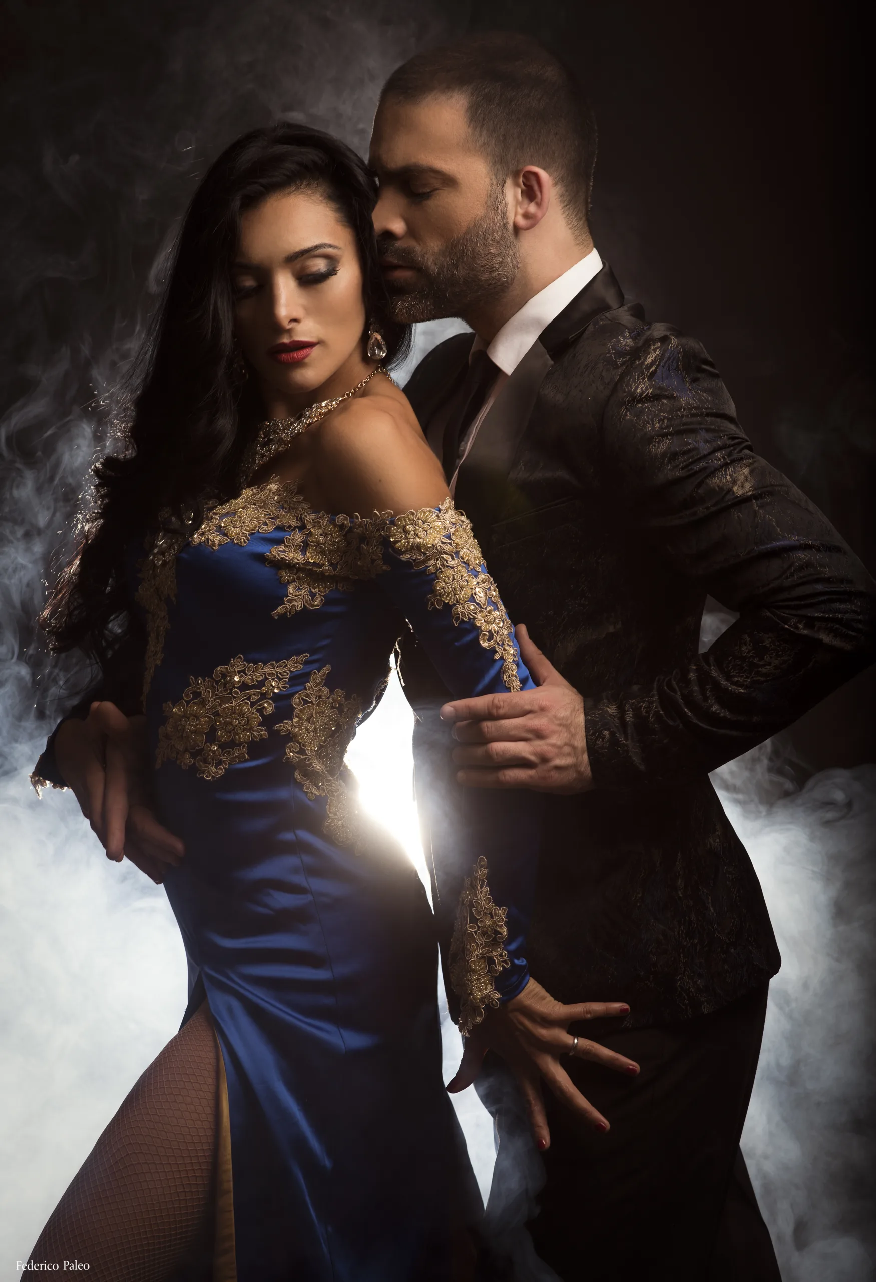 A man and a woman dancing tango in a close embrace.