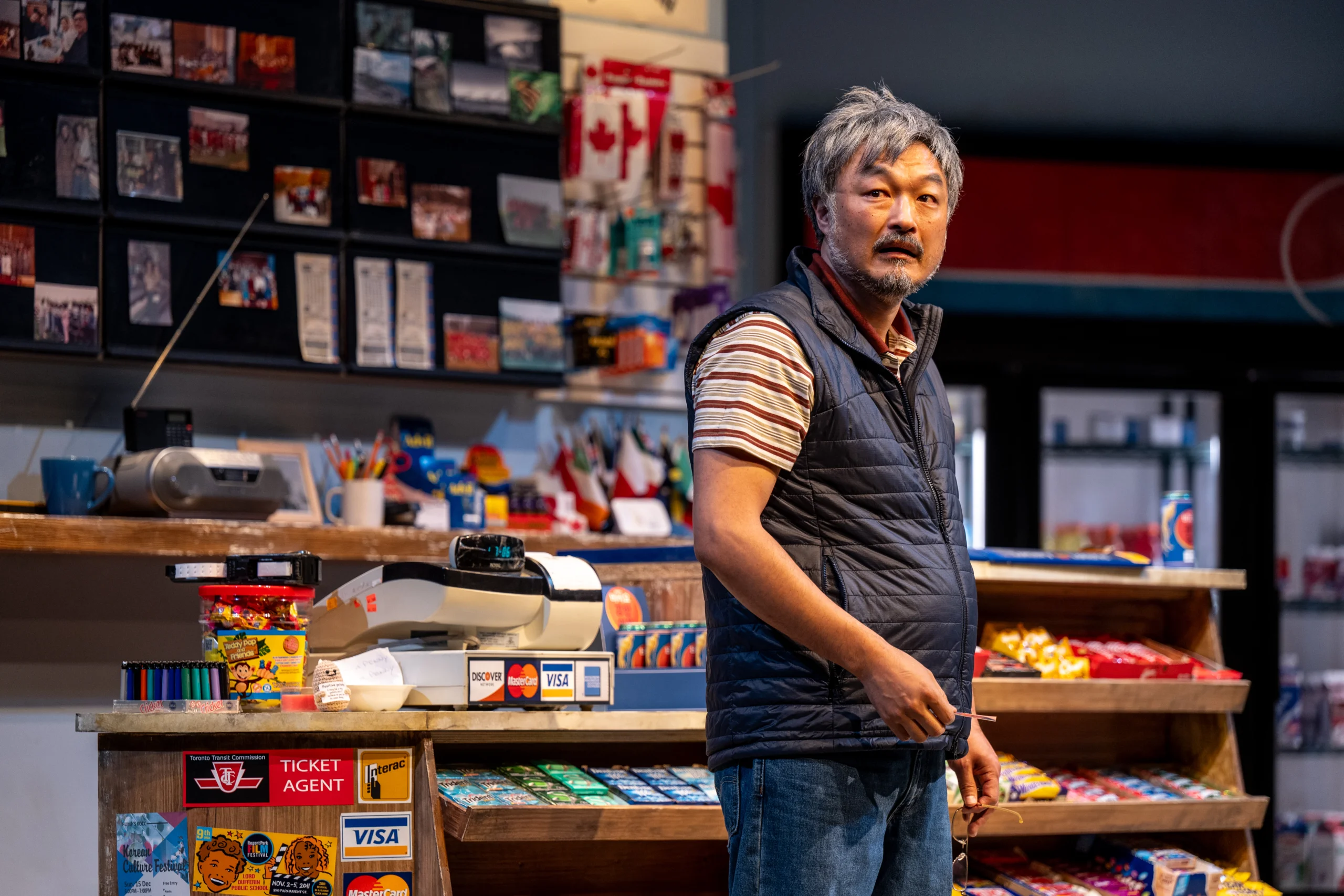 Mr. Kim standing in the convenience store. 