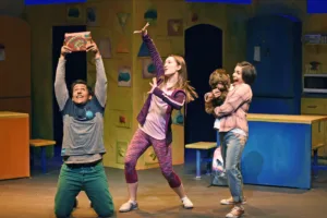 Actors on stage excited and celebrating.