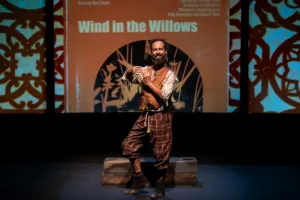 Man acting on a dimly lit stage