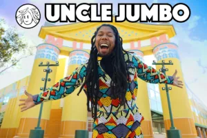 man smiling with arms widely stretched to the side Text reads: Uncle Jumbo