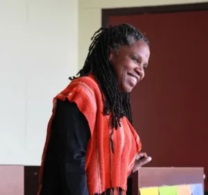 woman on stage smiling at the audience