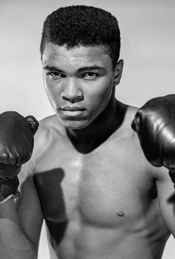 Black and white of Muhammad Ali with boxing gloves ready to box.