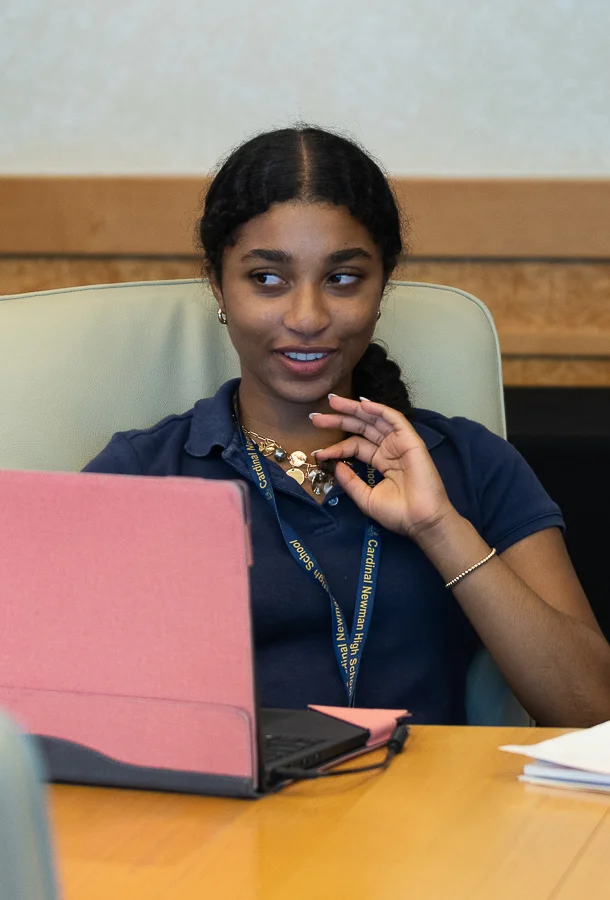 Young woman sitting at her computer at a table.