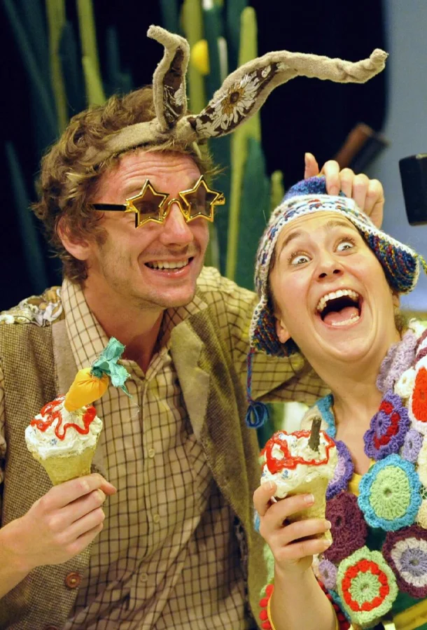 The Hare and the Tortoise (played by humans in costume) smiling for a selfie holding ice cream cones.