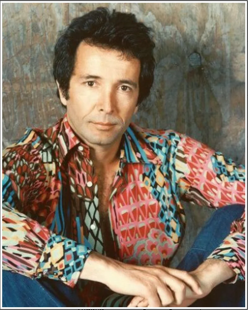 Herb Albert headshot in colorful shirt.