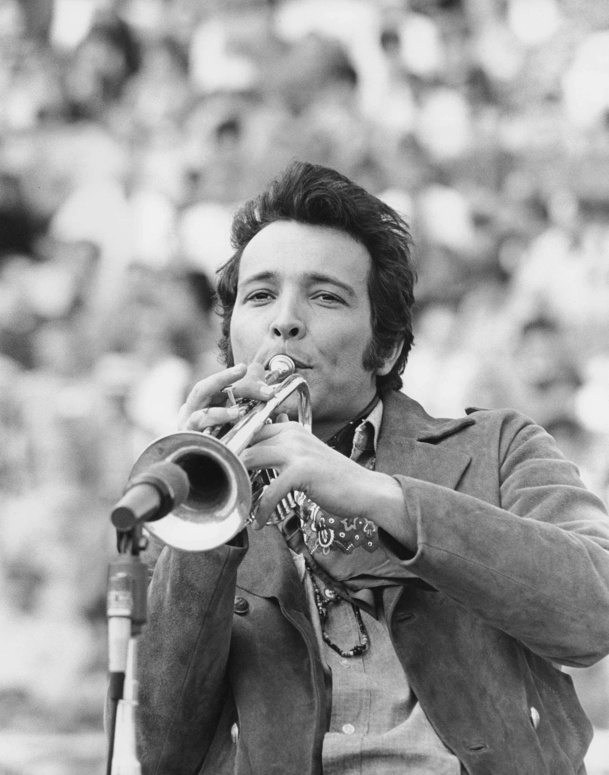 Black and white photo of Herb Albert playing trumpet.