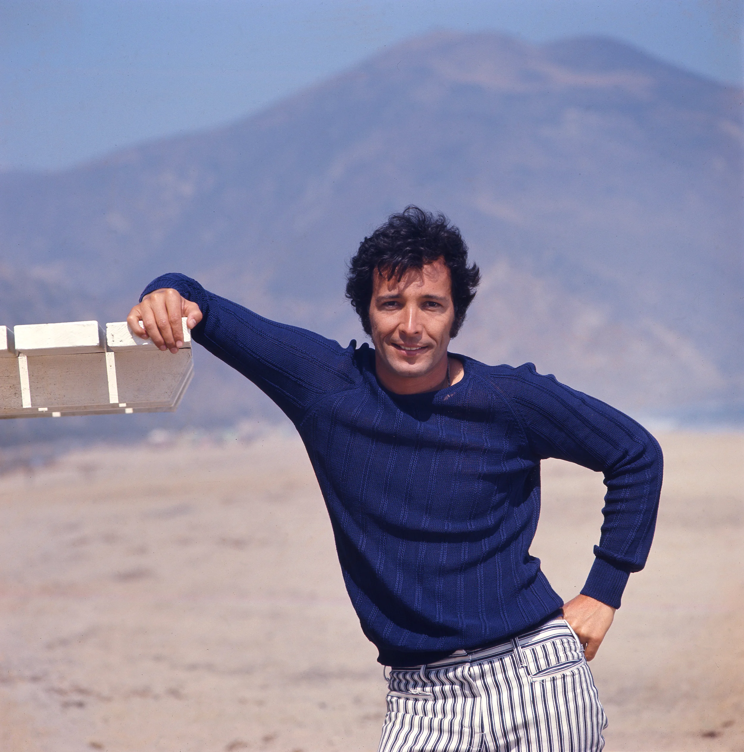 Herb poses wearing a blue shirt and stripe blue and white pants.