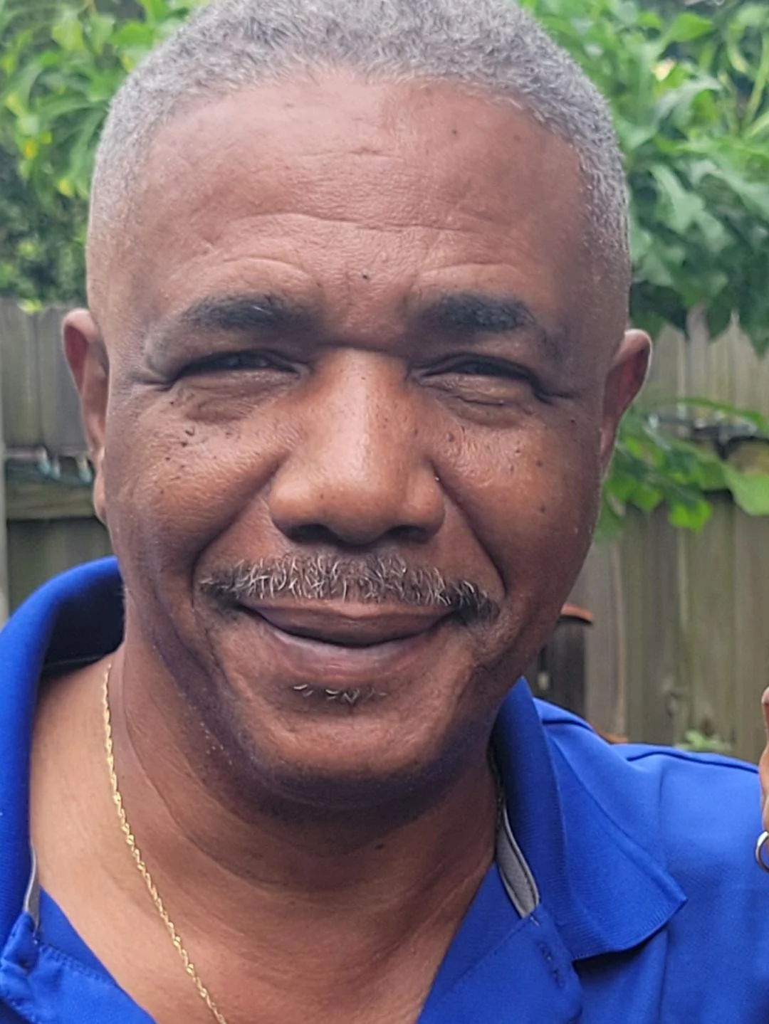 Jimmy Jaques headshot standing outside wearing a blue shirt. 