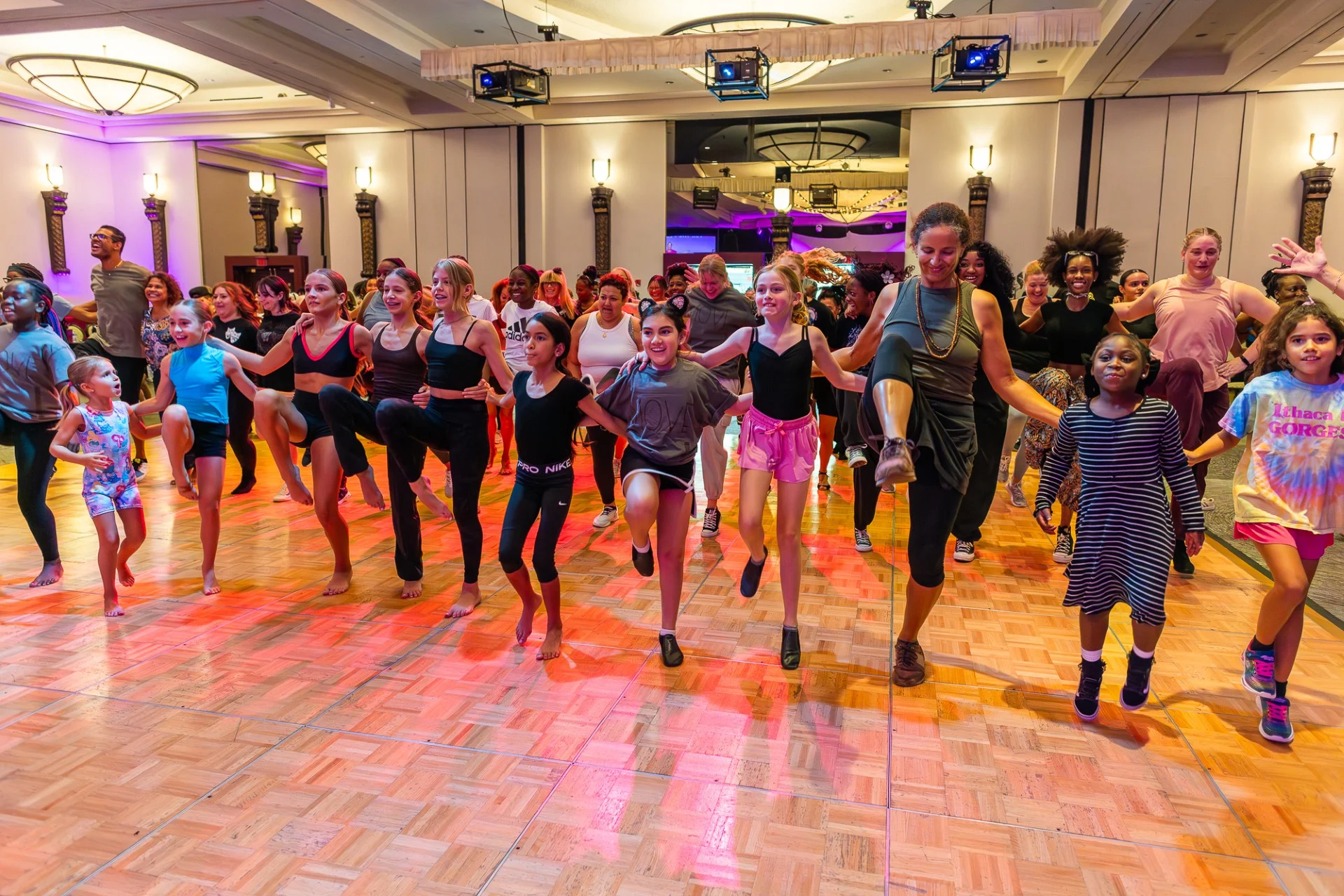 National Dance Day celebration featuring children and adults in a community dance workshop, participating in a group dance class.