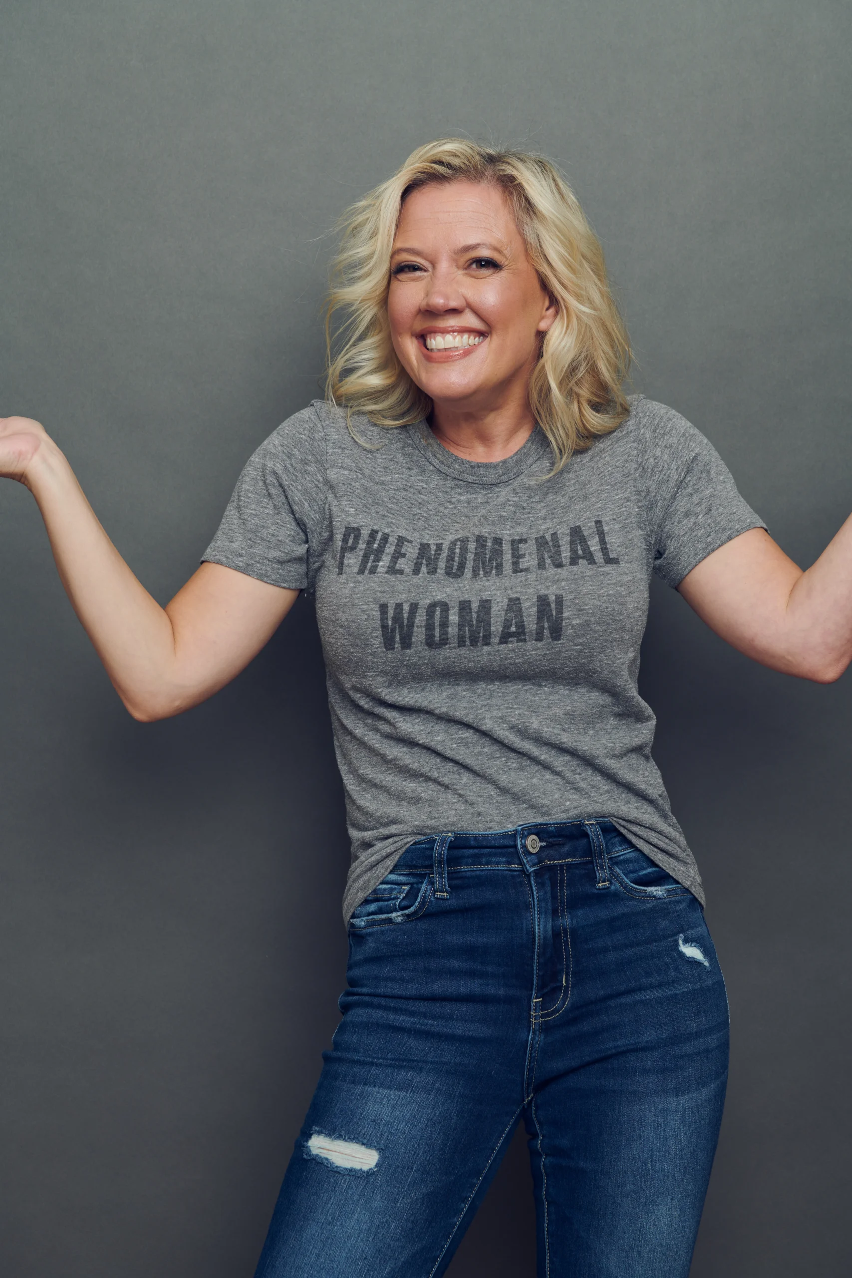 Patti Murin posing and smiling wearing gray 