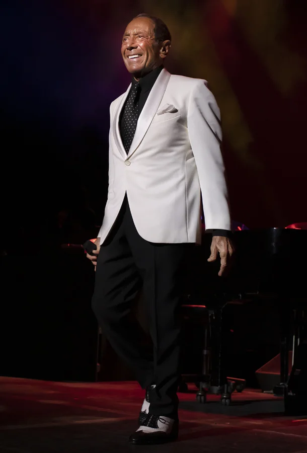 Paul Anka in white suit on stage.