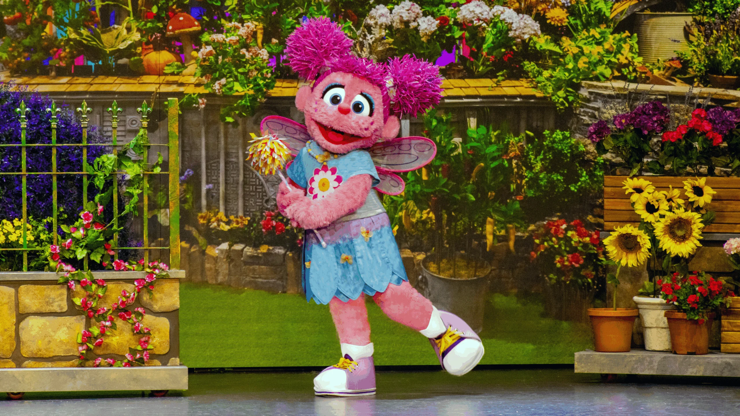 Abby Cadabby muppet character holding small pom pom wand in hand.