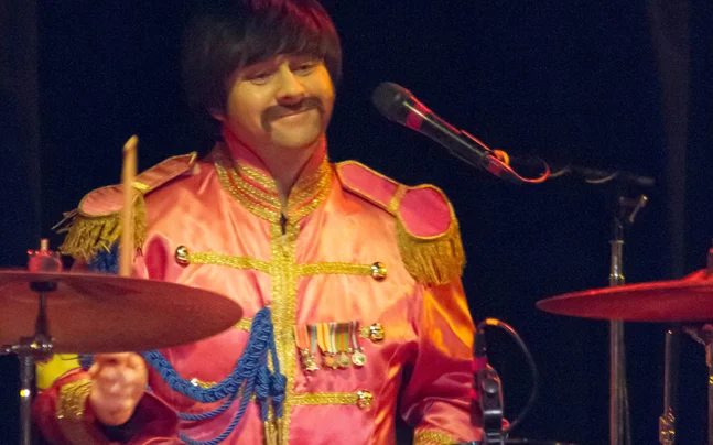 Beatles player performing drums.