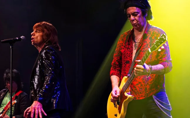 The Stones performing on stage.